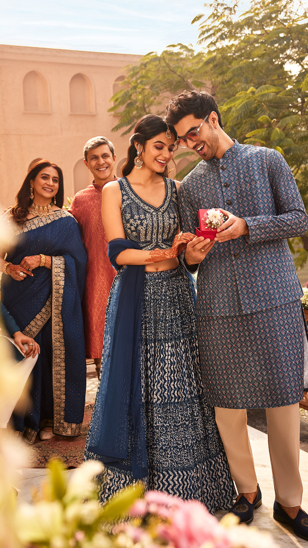 The groom's family sharing a warm, laughing moment of acceptance with the bride-to-be at the Roka ceremony.
